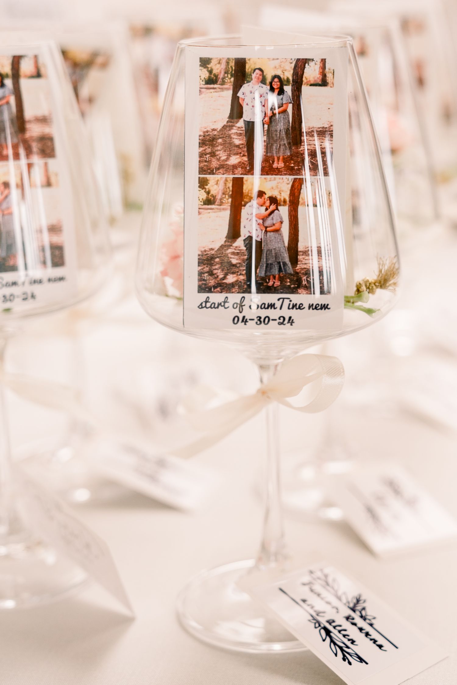 Commemorative wine glass displaying engagement photos with date inscription.