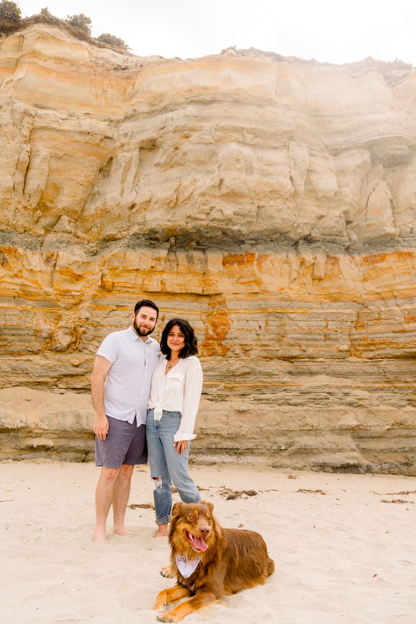 Romantic beach engagement session for San Diego couples at Del Mar Dig Beach with Pup