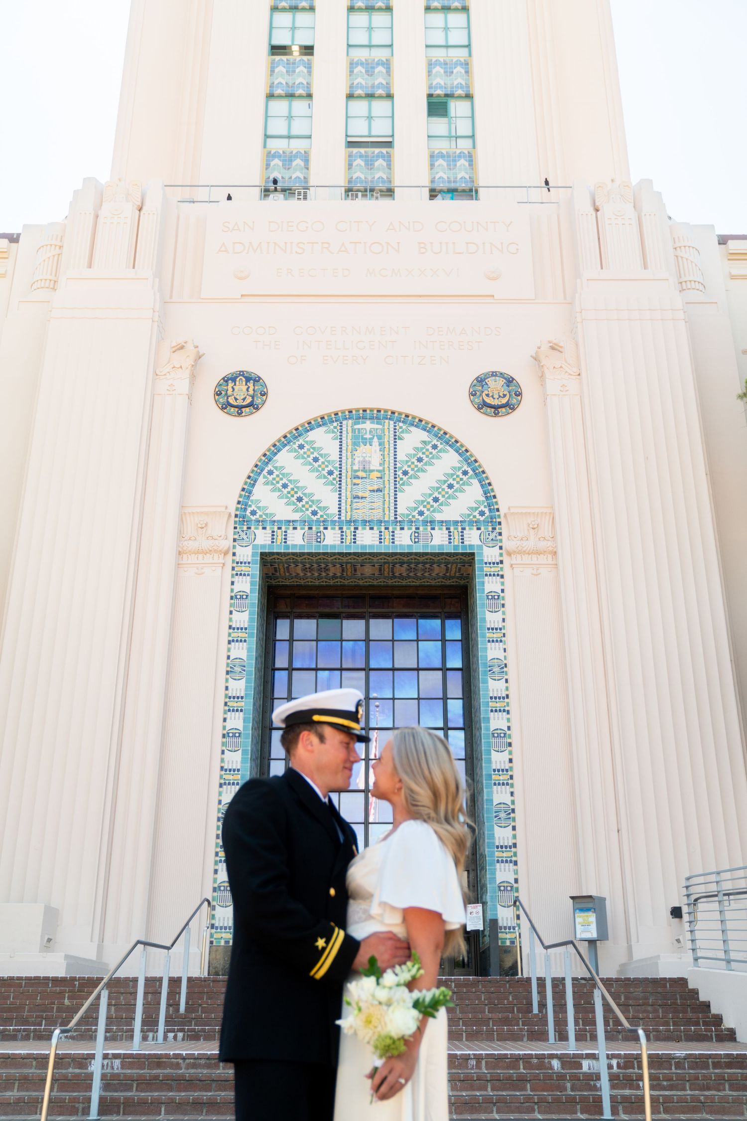 Art deco architecture features ornate details and grand entrance steps at a historic wedding venue.