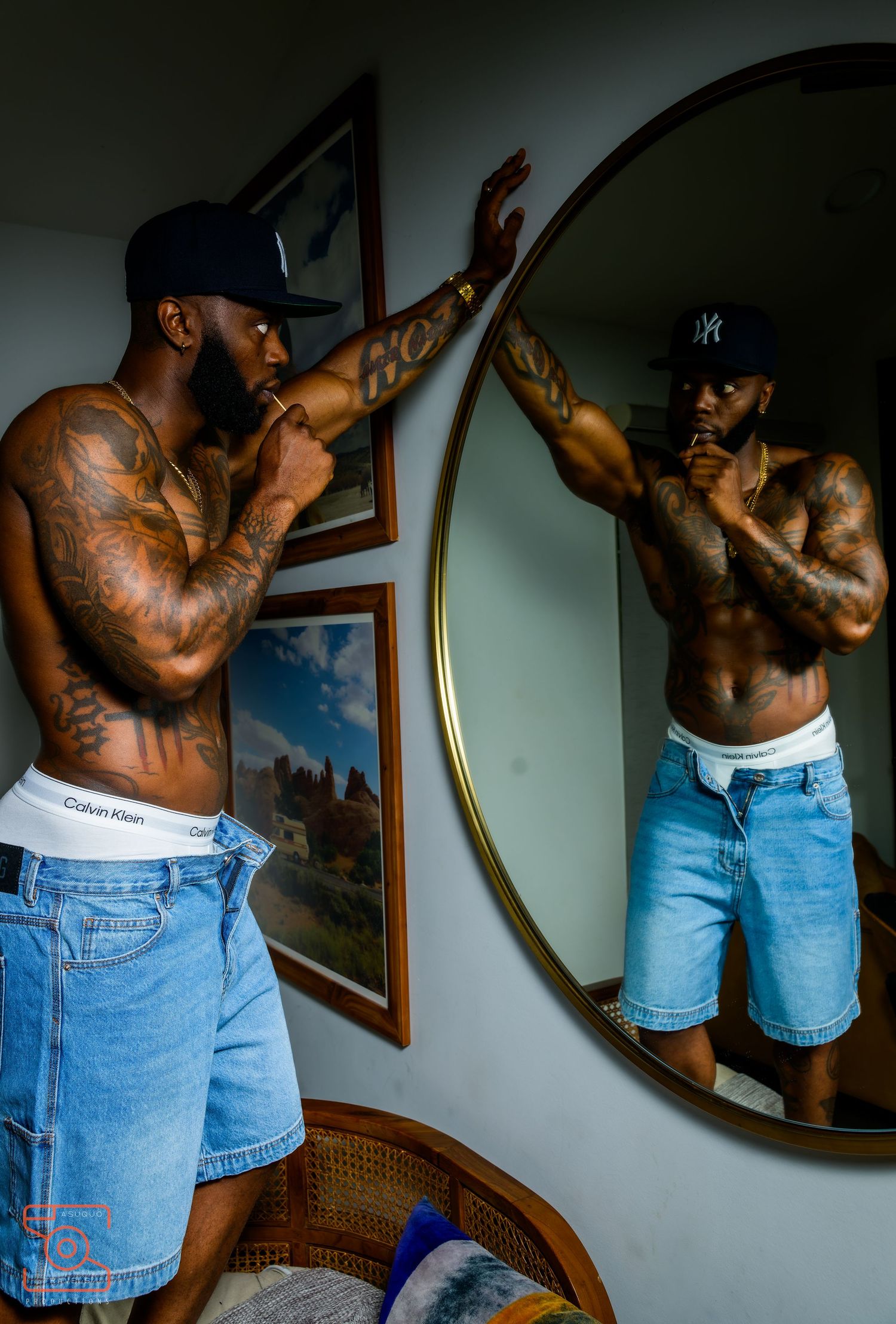 Artistic series of poses highlighting denim shorts and tattoos in moody indoor lighting.