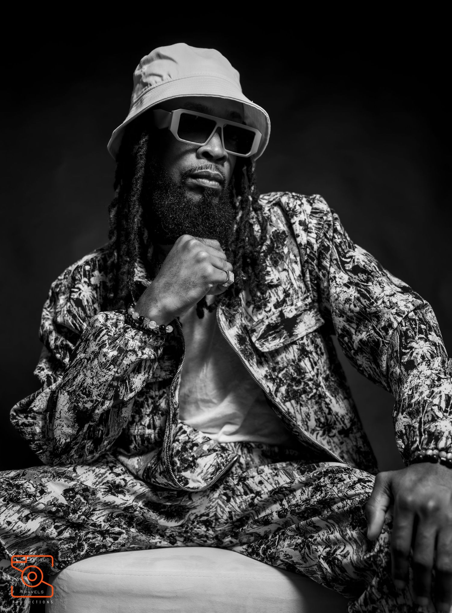 Black and white artistic photo sequence of a musician in sunglasses and patterned shirt performing with expressive movements.