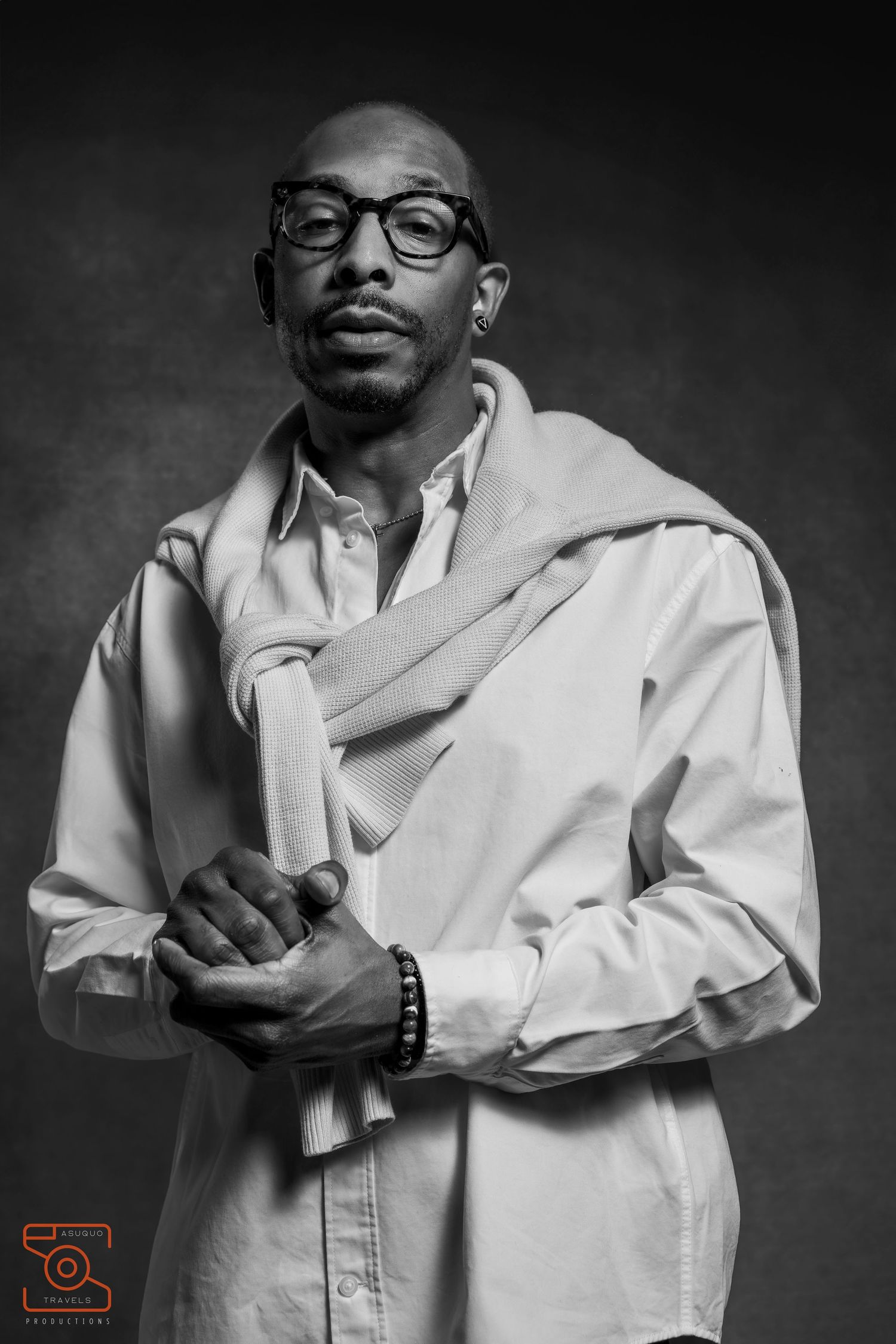 Artistic black and white portrait series showing figure in white coat against dark background.