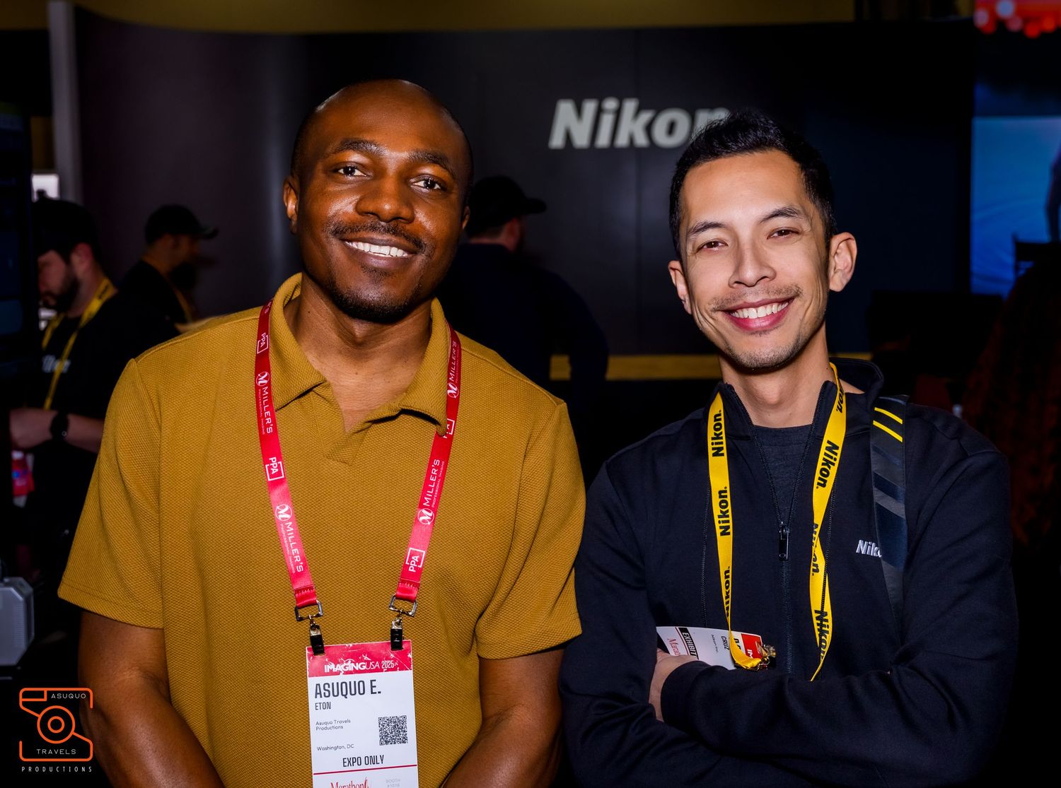 Group of conference attendees wearing lanyards smiling together at an event.