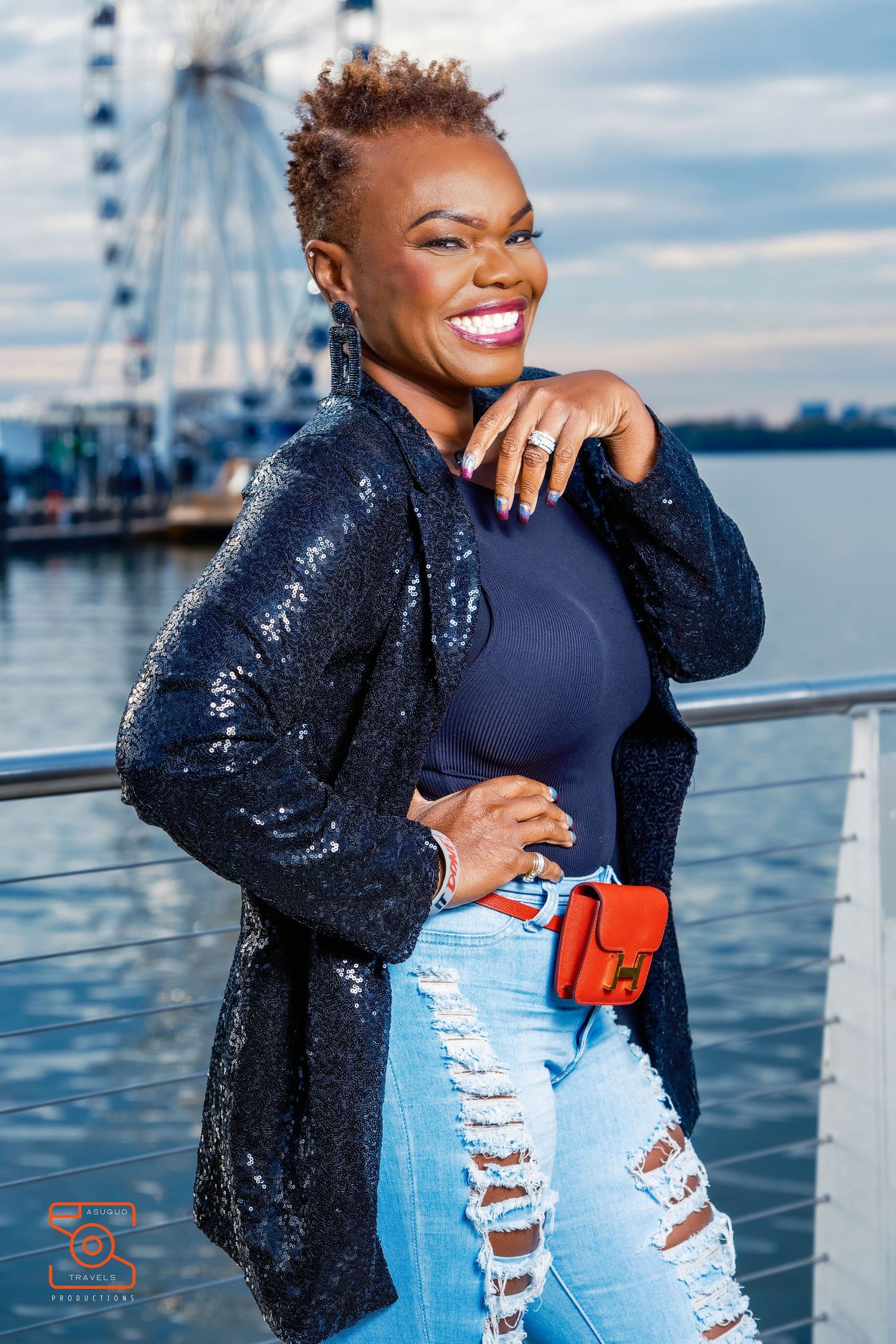 Fashion portraits by waterfront featuring sparkly jacket and distressed denim.