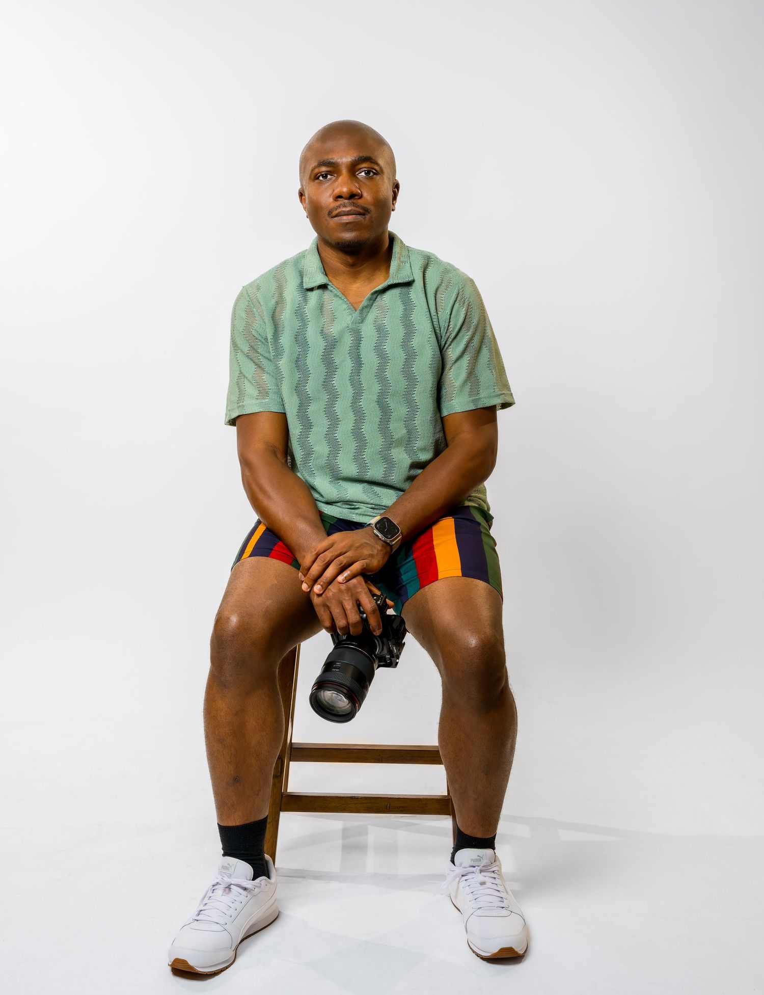 Studio photography session featuring casual attire and camera equipment.