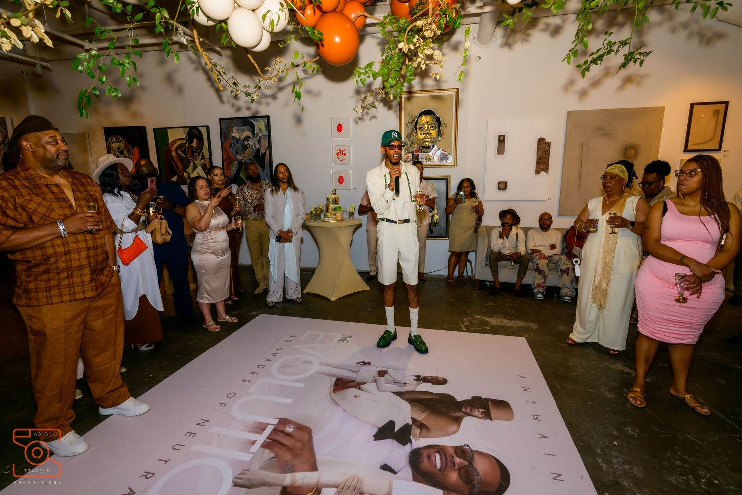 Group of wedding guests watch an entertaining performance on a white dance floor during reception celebration.