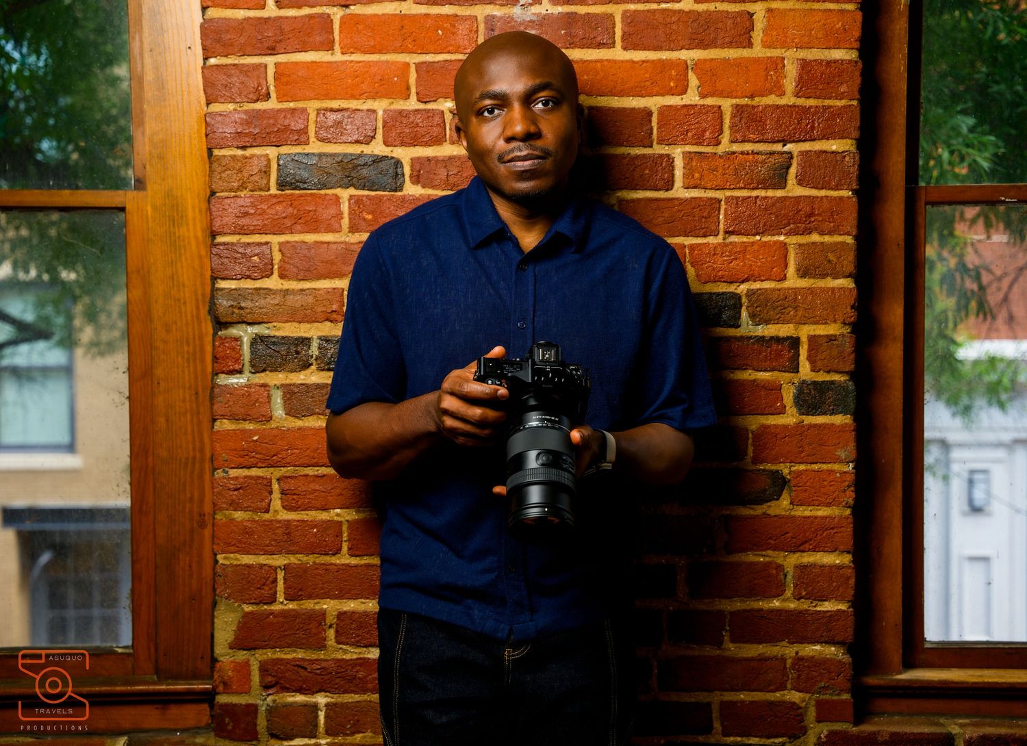 Camera equipment arranged against a rustic brick wall background.