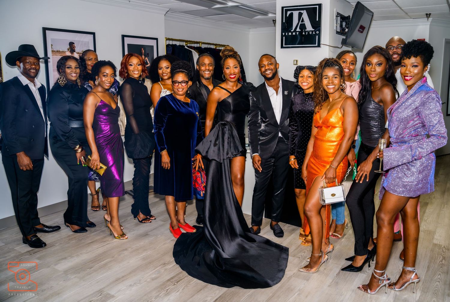 A group poses together at what appears to be a formal event or gathering with people wearing dressy attire.