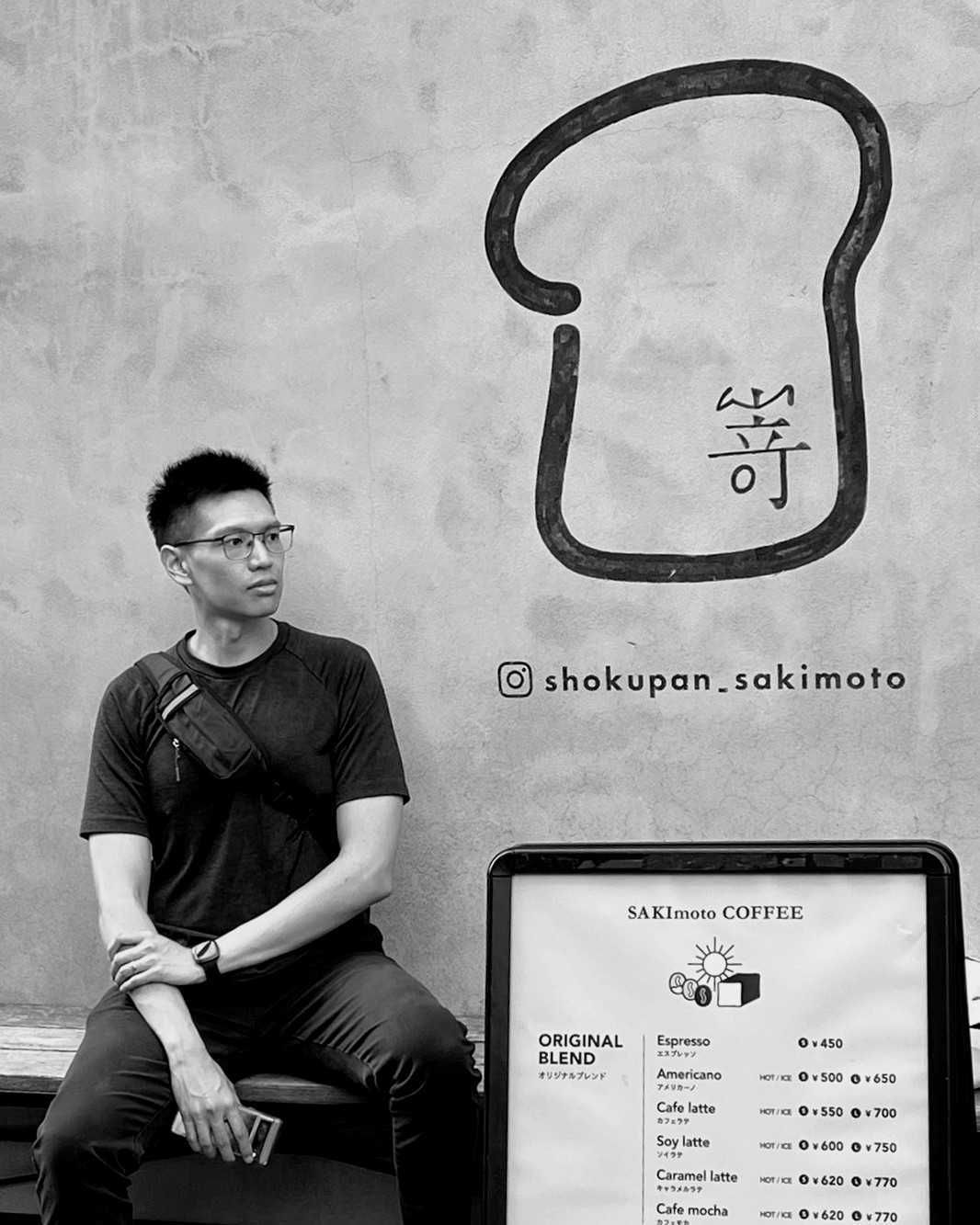 Menu board and coffee shop exterior with minimalist black and white aesthetic.