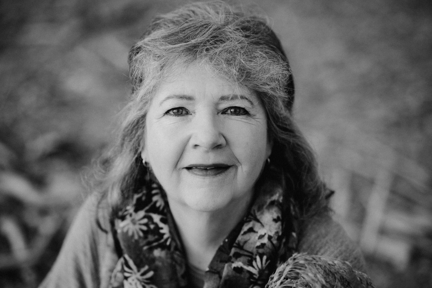 Black and white portrait showing joyful expression and natural lighting.