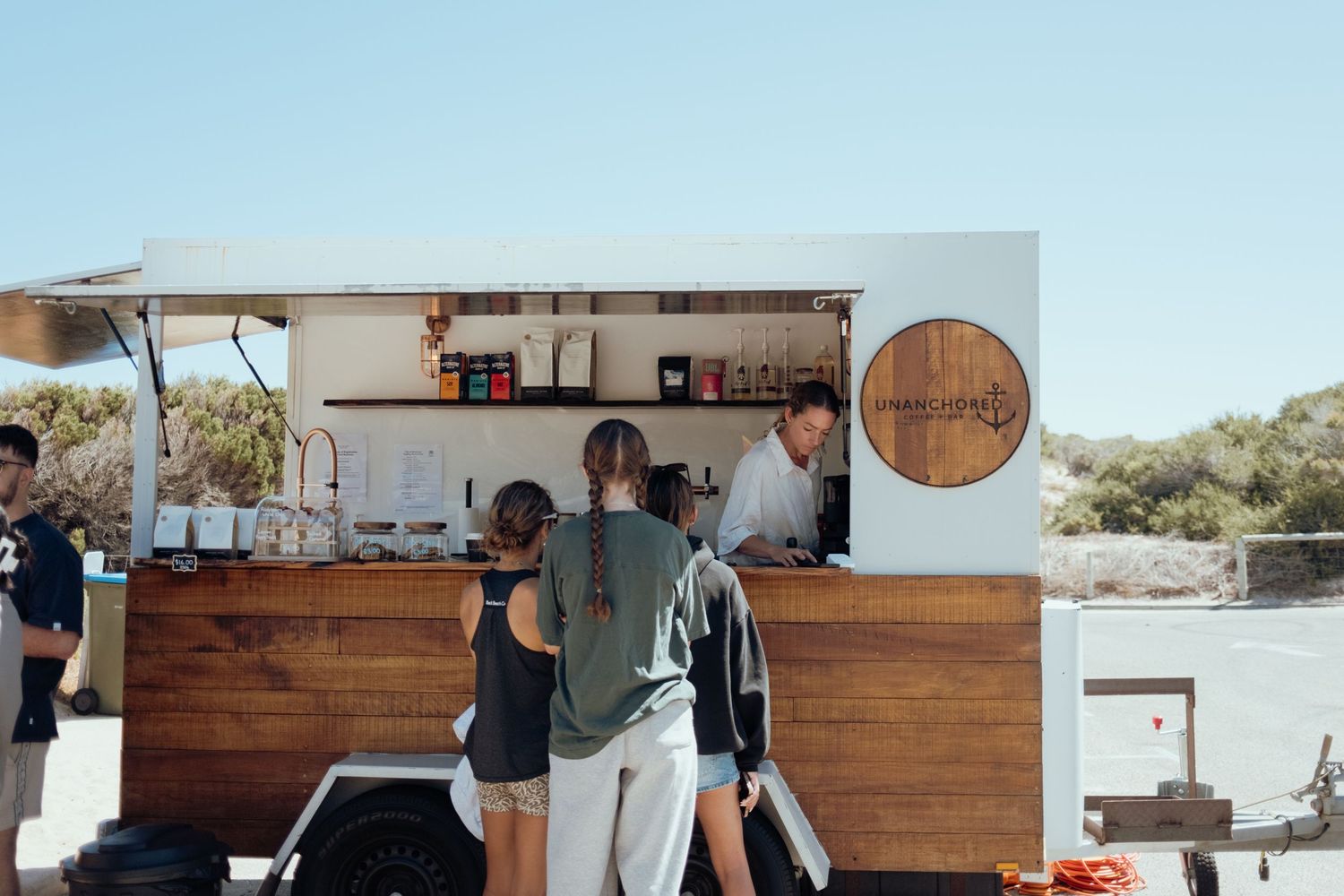 Modern wooden bar setup with rustic decor and serving equipment.