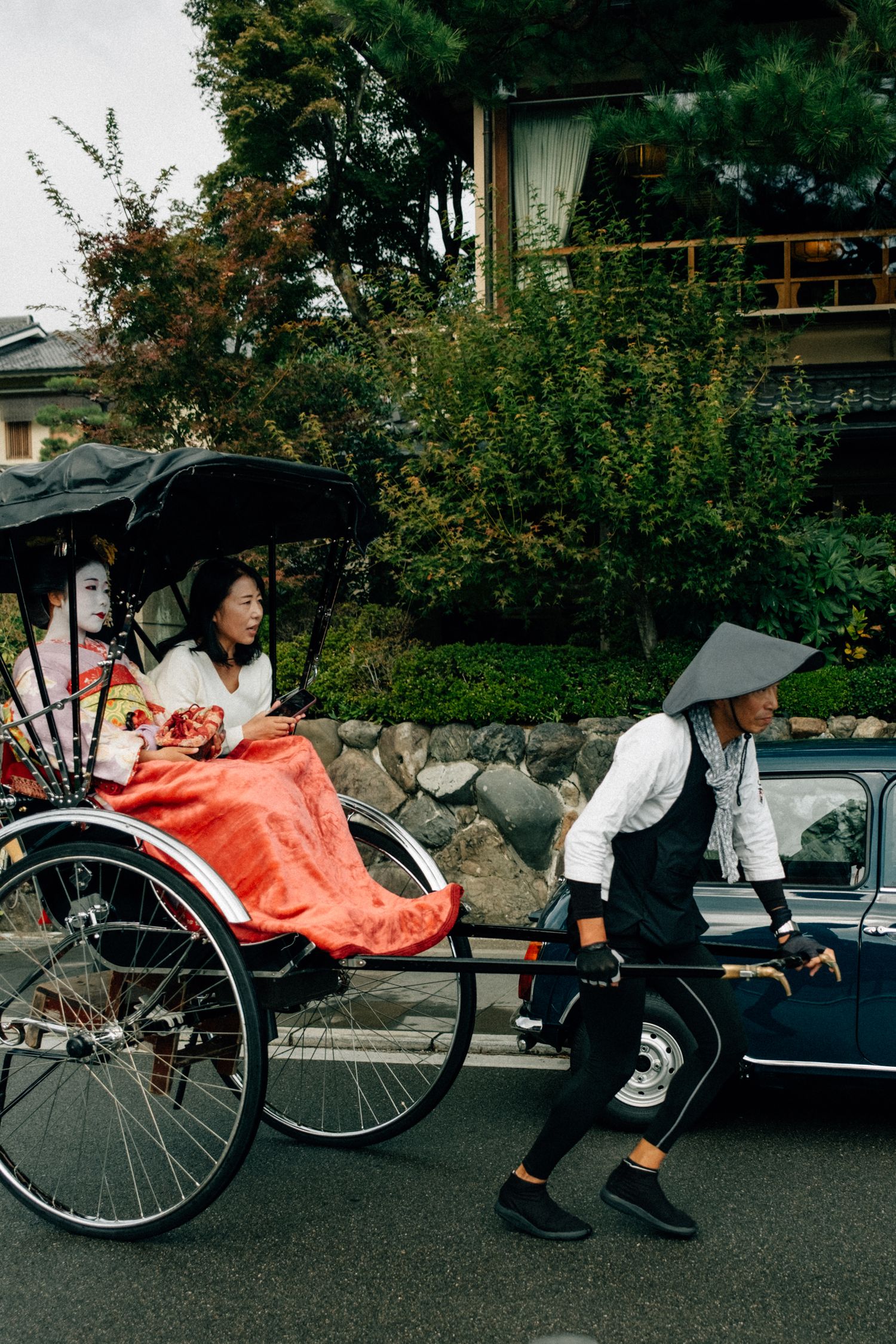 Traditional rickshaw pullers in Japan waiting for customers on a city street.