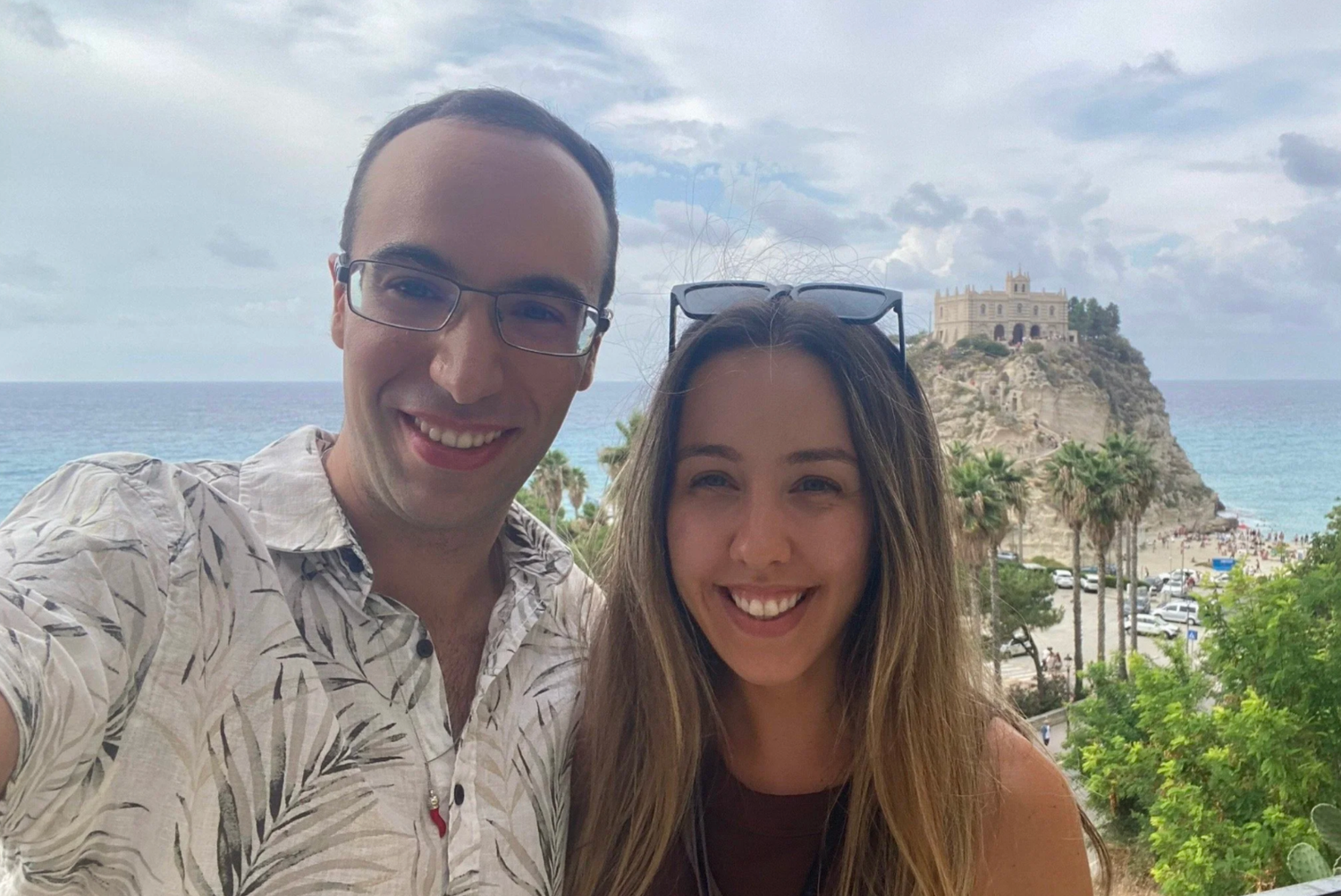 Friends taking selfies together with scenic coastal views in the background.