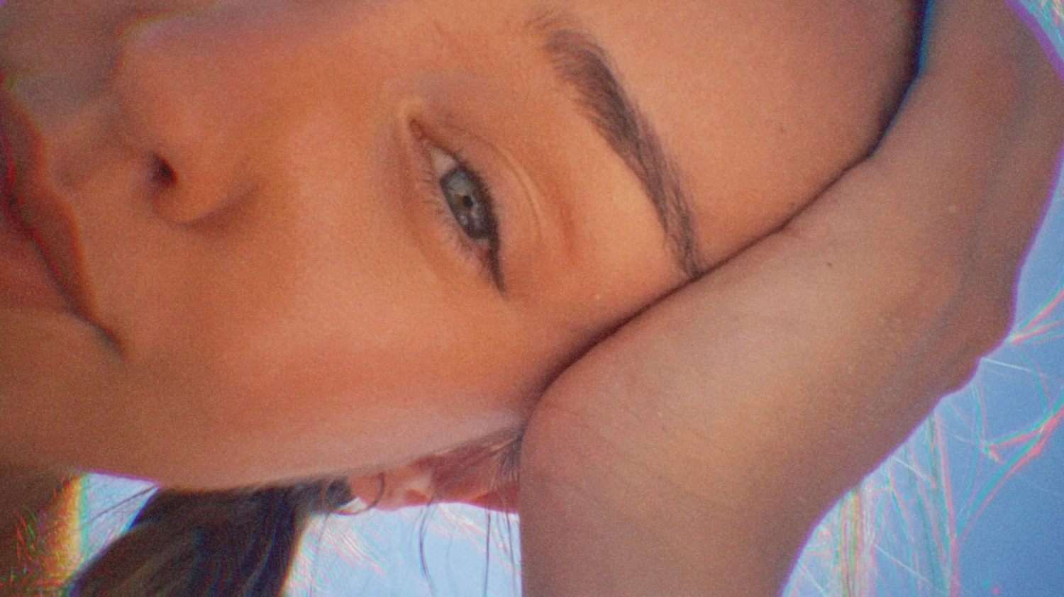 Close-up artistic portrait with soft lighting and blue tones.