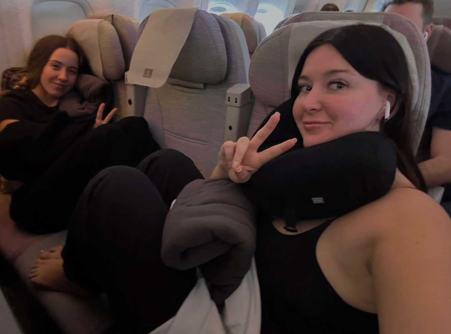 Passengers relaxing in comfortable airplane seats during a flight.