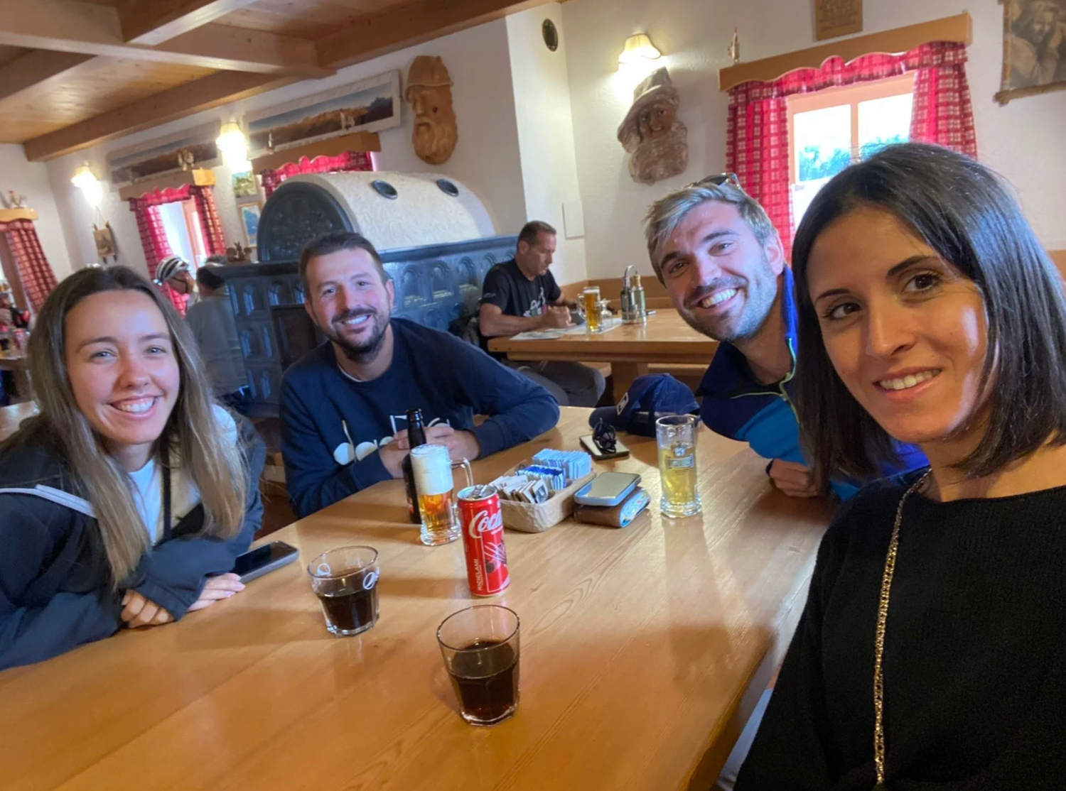 Group dining together at a casual restaurant with red checkered curtains.