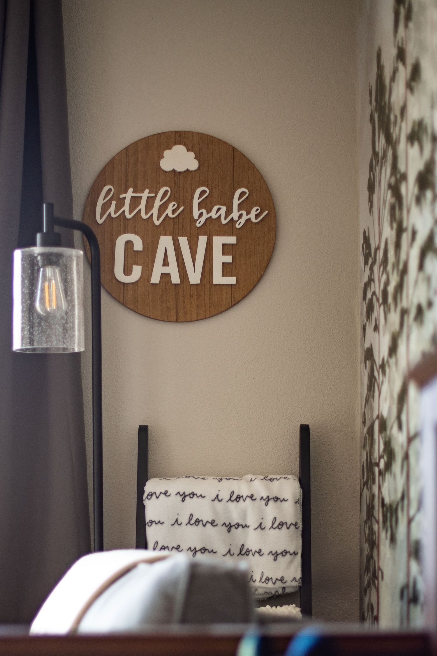 Rustic wooden wall signs with 'Cave' and 'Little Babe' text displayed in a cozy bedroom nursery setting. Located in Salem, OR