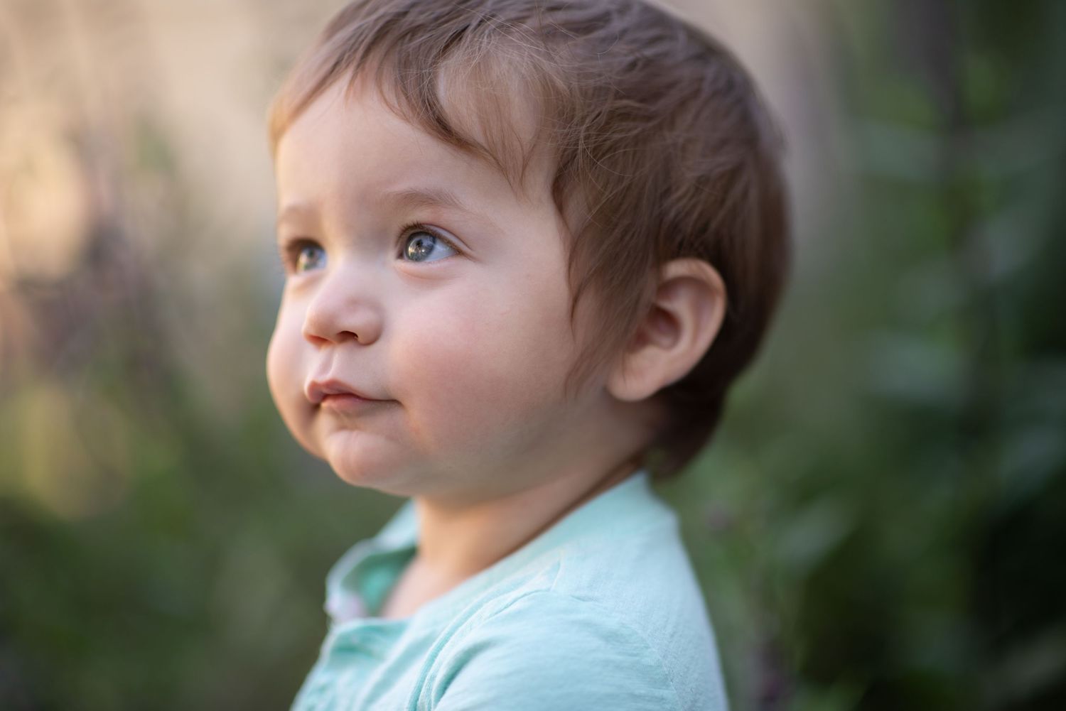 A collage of seven outdoor portrait photos showing different expressions and angles in natural lighting.