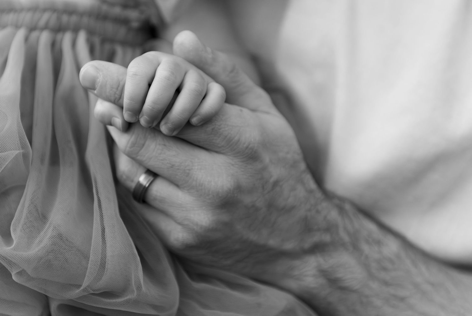 detailed image of Toddler girl holding dads hand located in an open field in Salem, OR