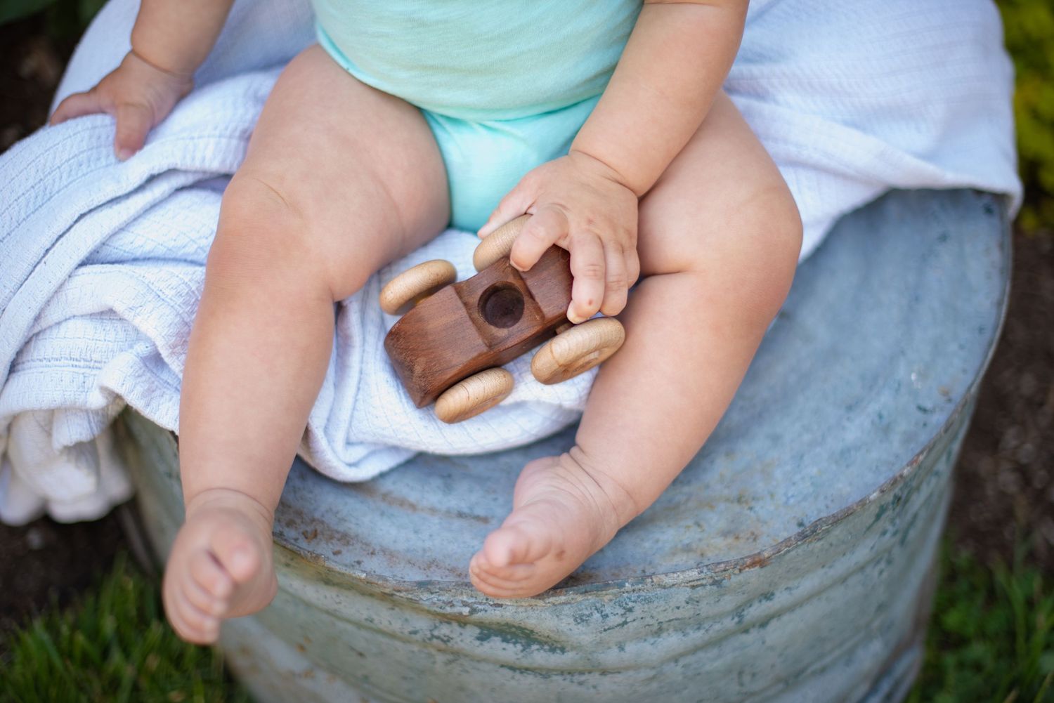 detailed image of hands and feet and a wooden toy