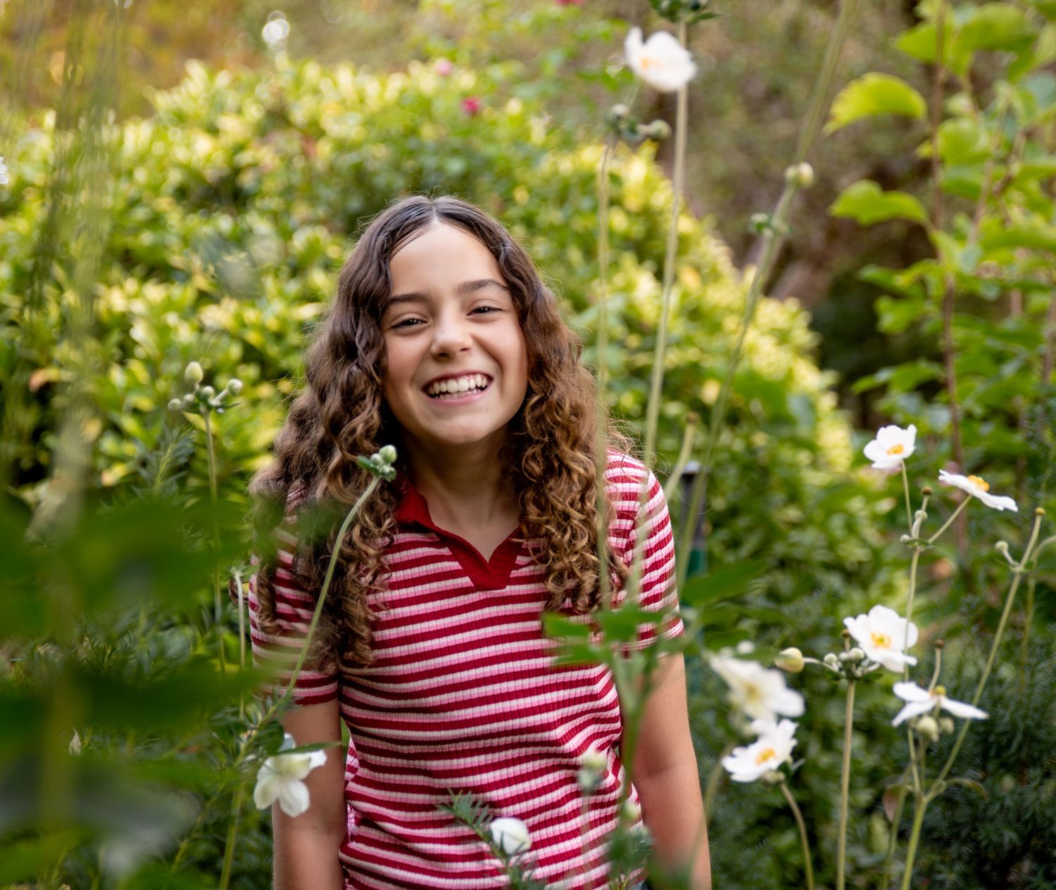 Child Headshot image among late fall flowers in bush pasture park Salem, OR.