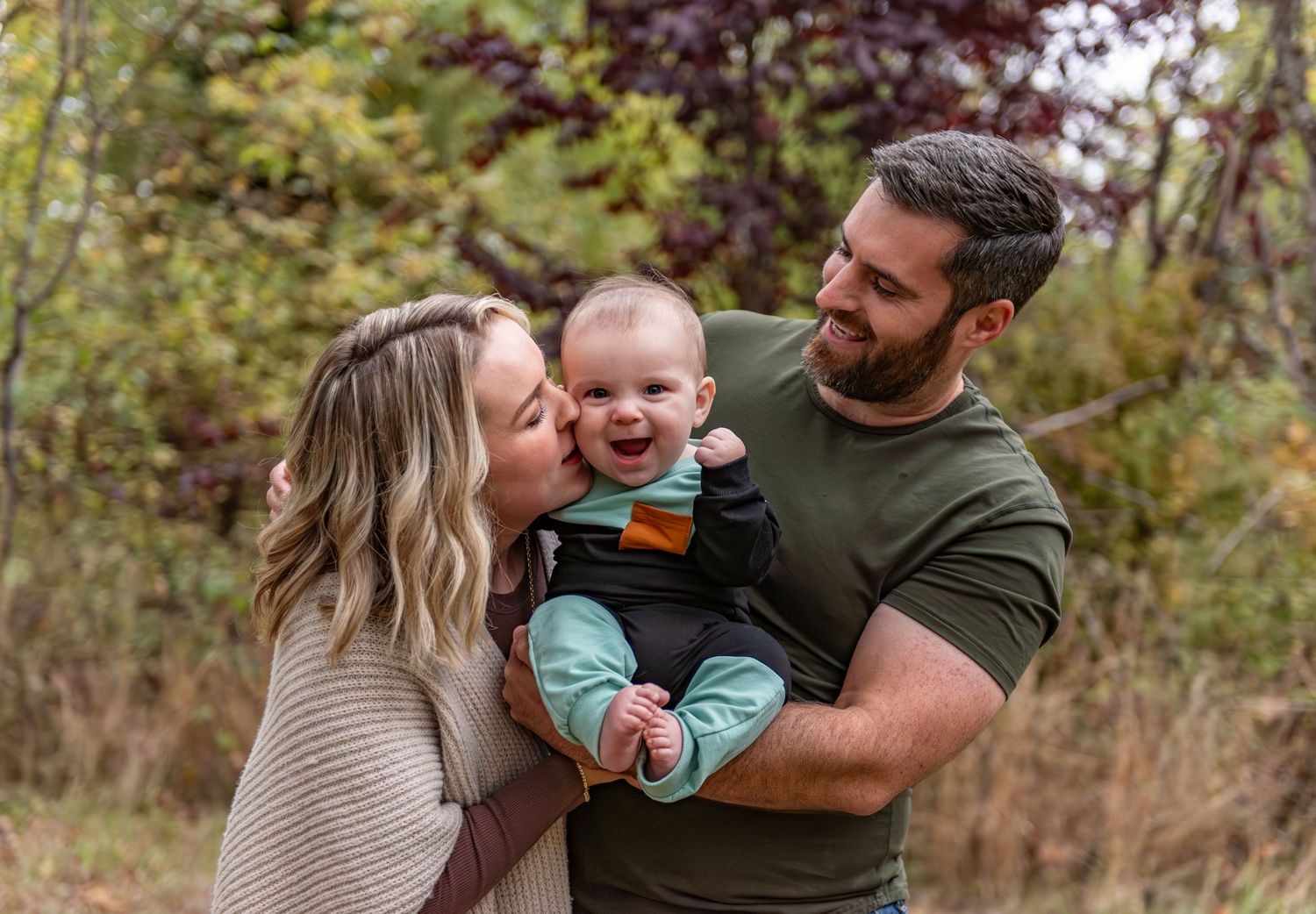 A family shares joyful moments together outdoors during an autumn photoshoot in a natural setting. Salem, OR