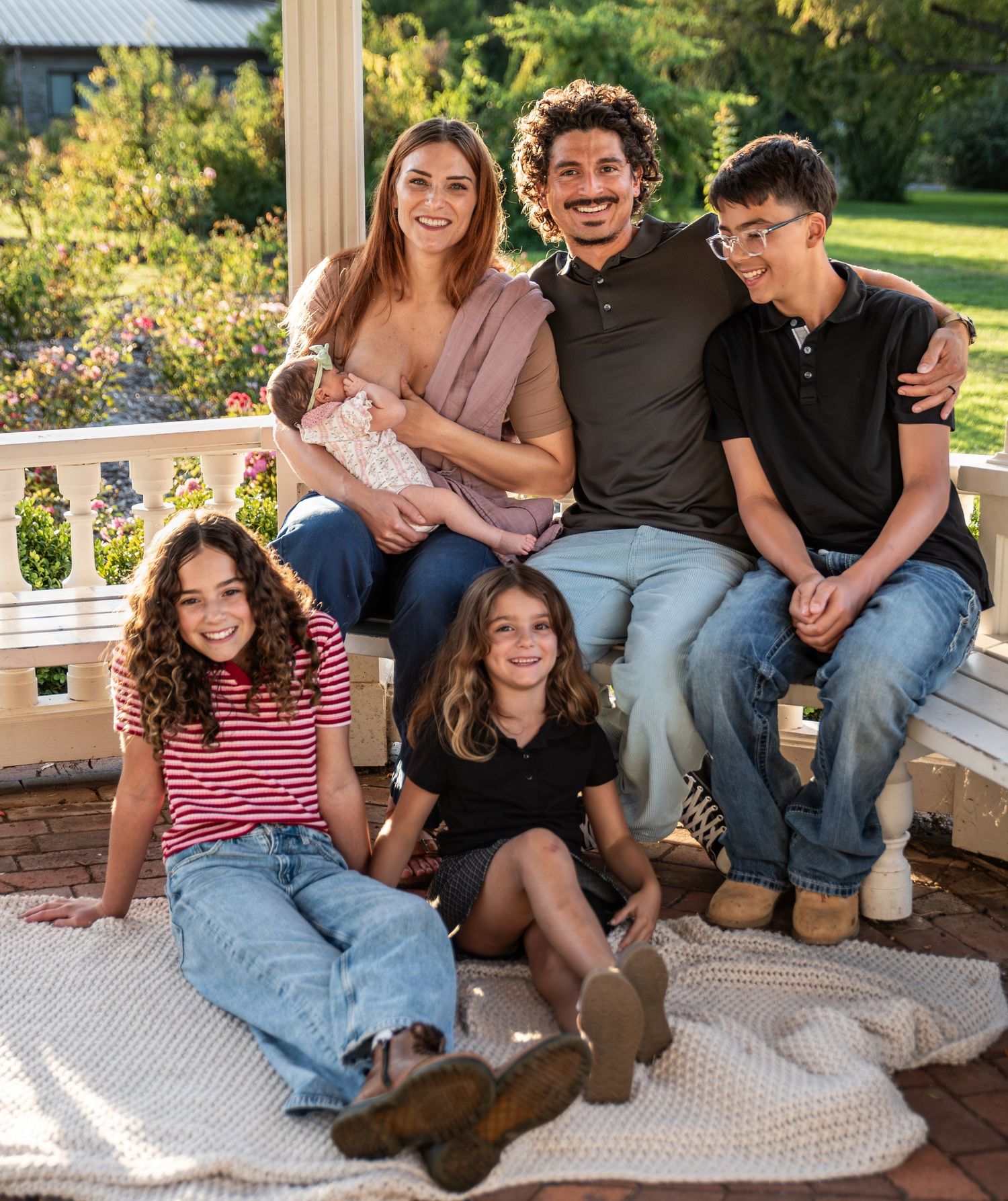 Family gathered under a gazebo on a sunny day for a family portrait photo in Salem, OR.