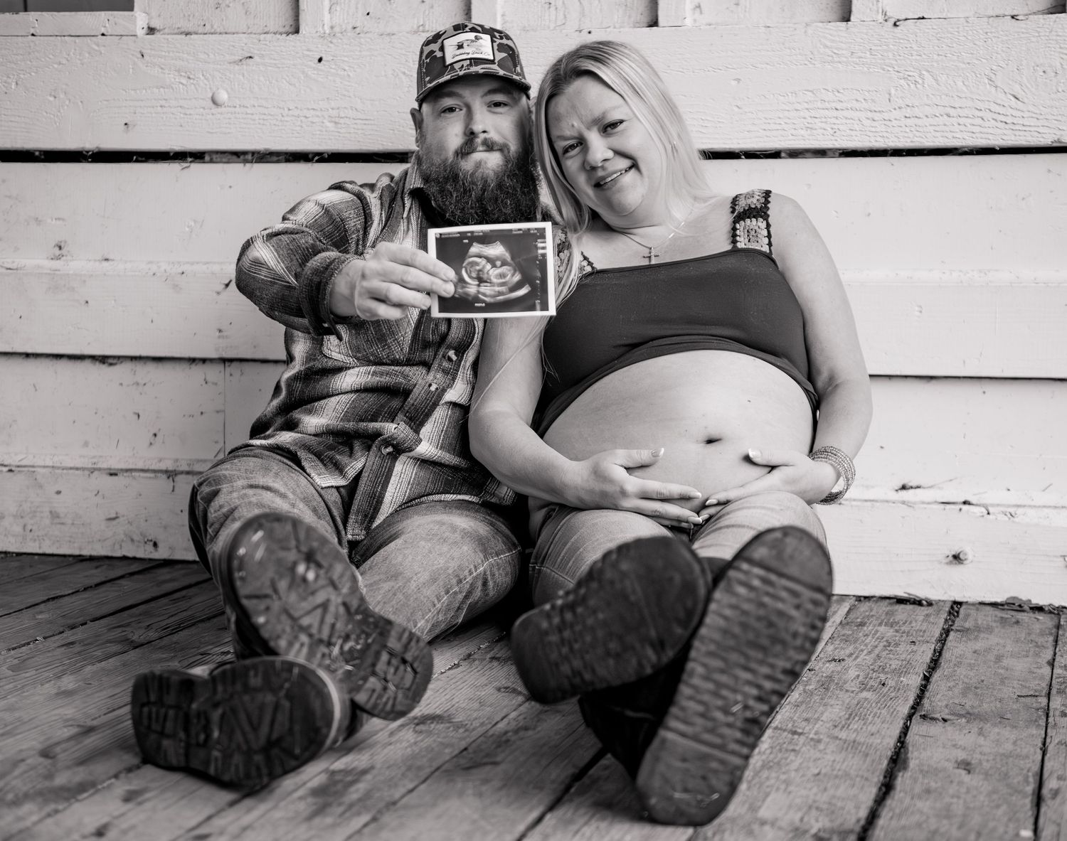 Mom and dad holding sonogram photo posed for a maternity session located in Stayton, OR