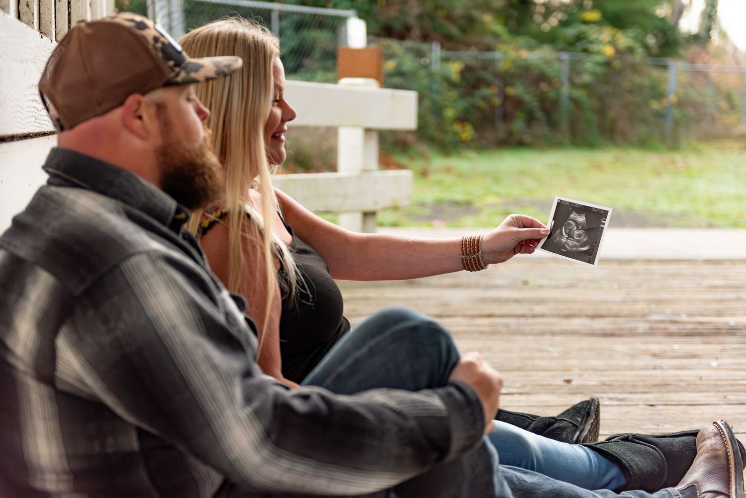 Mom and dad holding sonogram photo posed for a maternity session located in Stayton, OR