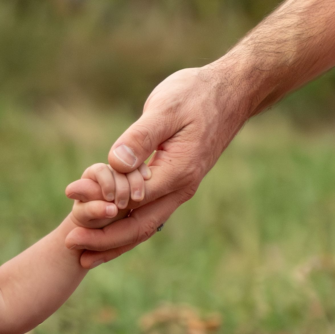 detailed image of Toddler girl holding dads hand located in an open field in Salem, OR