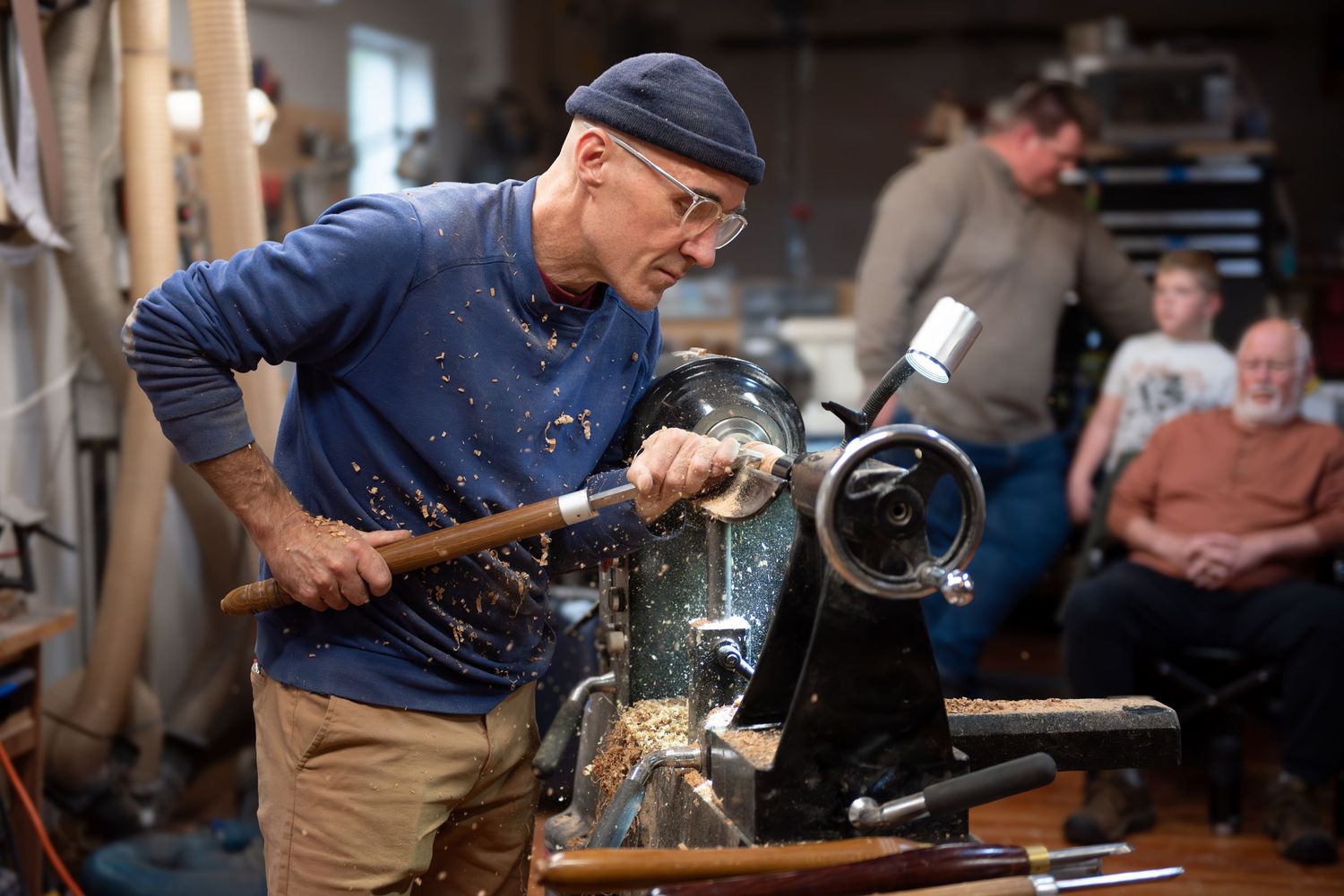 world renowned wood turner turning wood in a wood shop with wood working tools and lathe located in Turner, OR