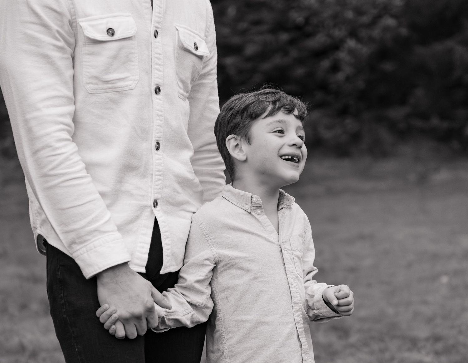 A series of black and white photos showing children in white shirts playing and laughing outdoors. Silver Falls State Park OR
