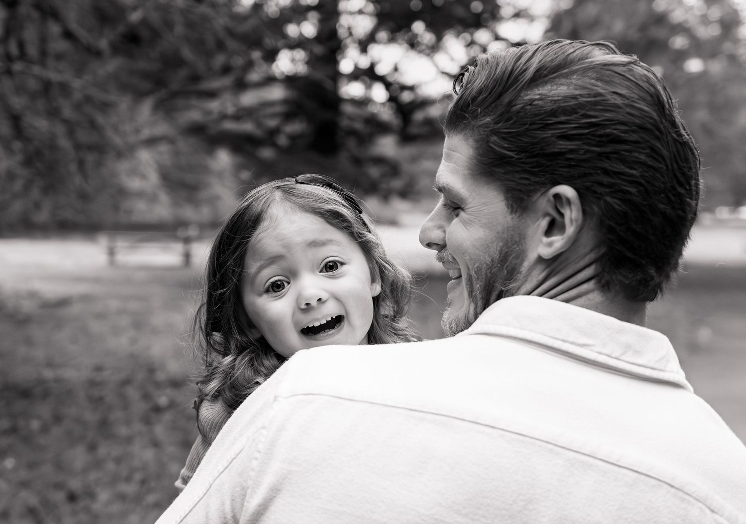 A series of black and white candid photos showing joyful moments between two people in an outdoor setting. Silverton, OR