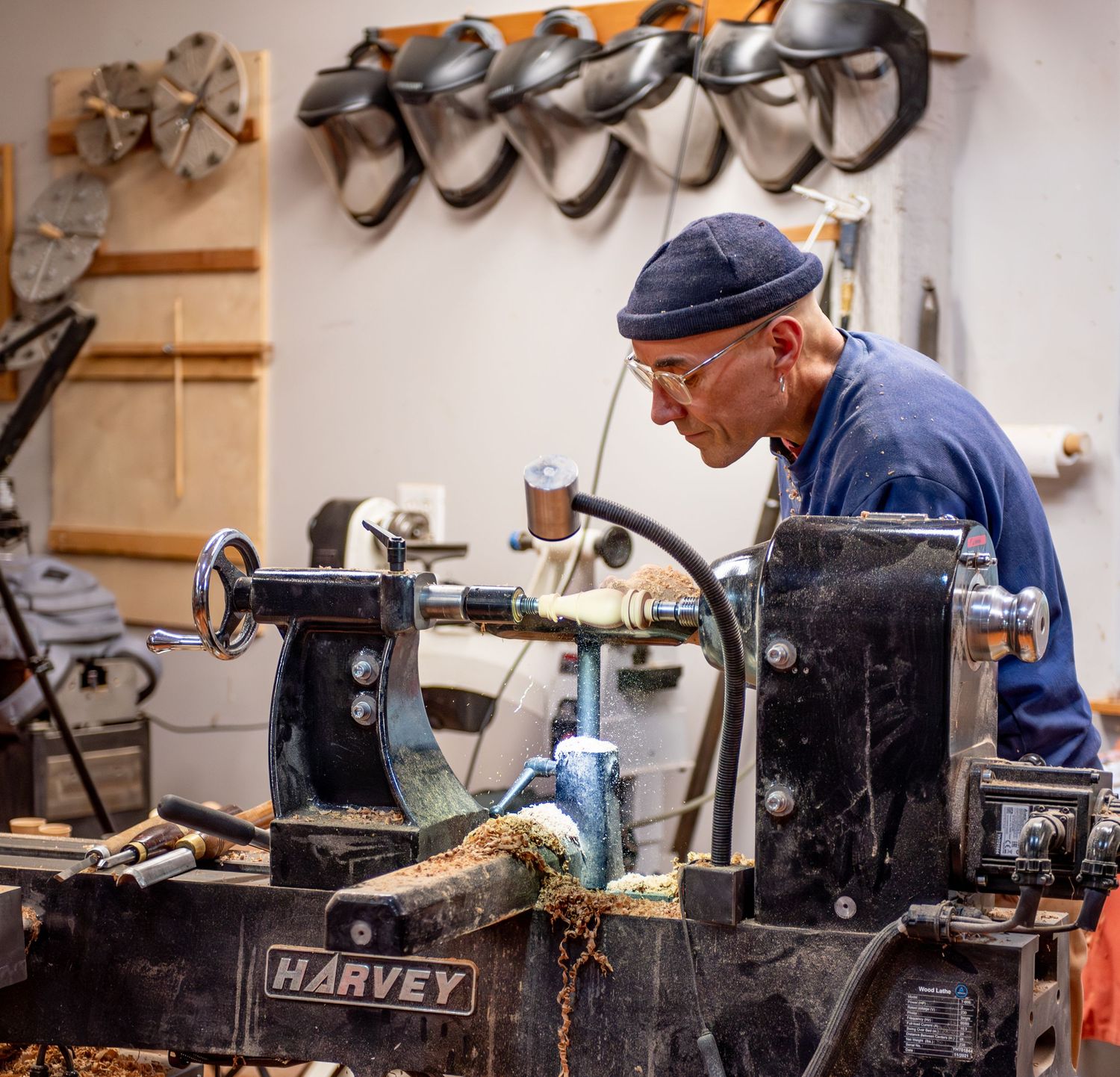 world renowned wood turner turning wood in a wood shop with wood working tools and lathe located in Turner, OR