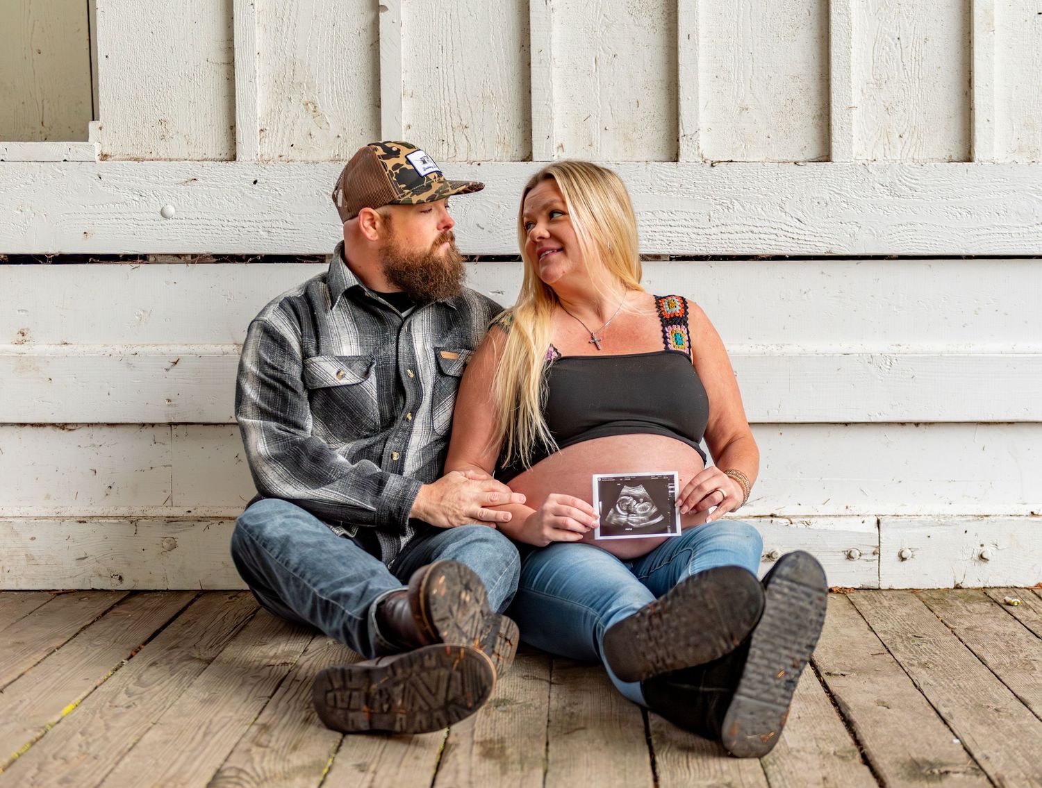 Mom and dad holding sonogram photo posed for a maternity session located in Stayton, OR