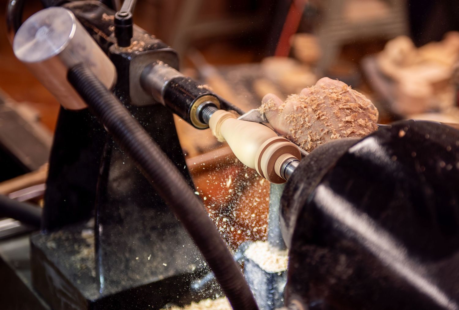 world renowned wood turner turning wood in a wood shop with wood working tools and lathe located in Turner, OR