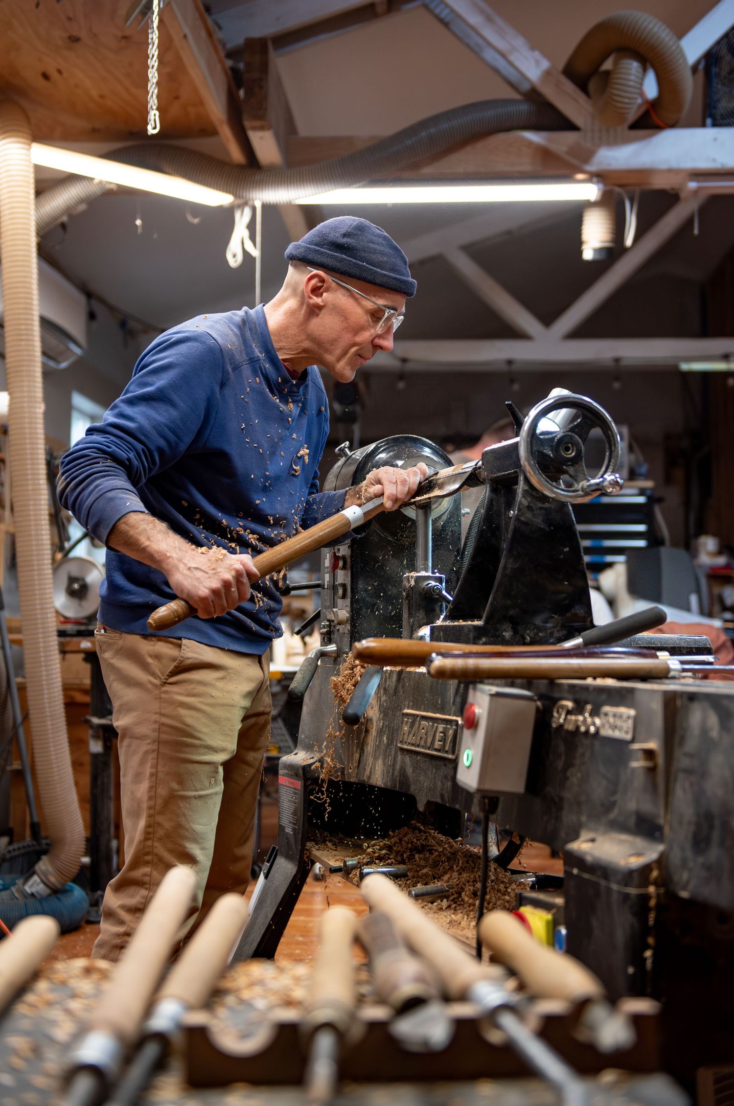 world renowned wood turner turning wood in a wood shop with wood working tools and lathe located in Turner, OR
