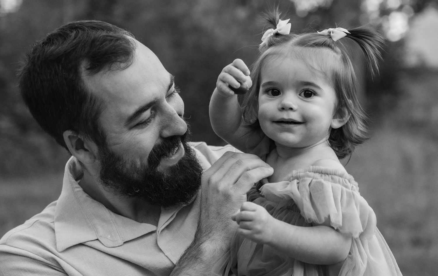 Dad holding daughter toddler  in a black and white image located in Salem, OR