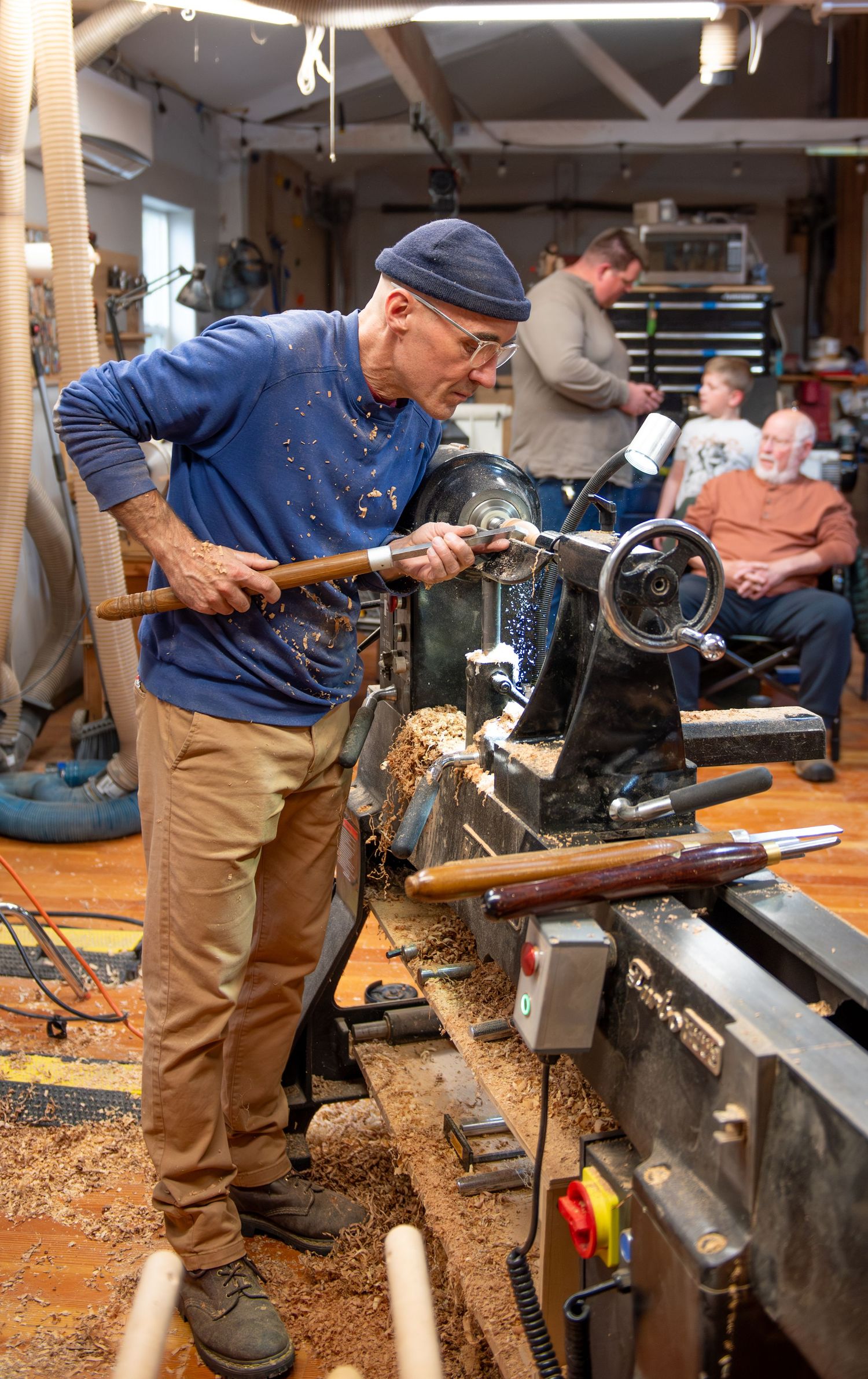world renowned wood turner turning wood in a wood shop with wood working tools and lathe located in Turner, OR