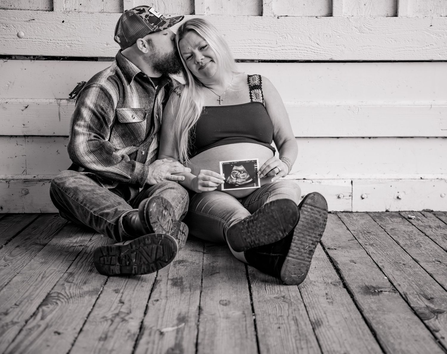 Mom and dad holding sonogram photo posed for a maternity session located in Stayton, OR