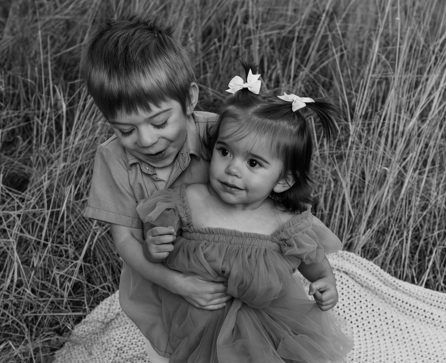 young Brother and sister posed together in a field located in Salem, OR