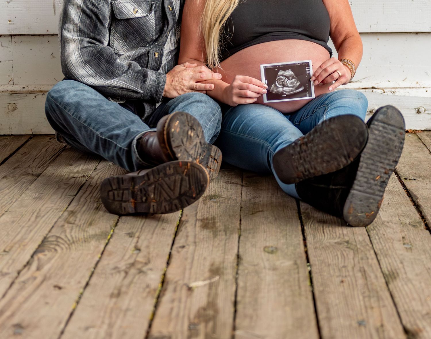 Mom and dad holding sonogram photo posed for a maternity session located in Stayton, OR