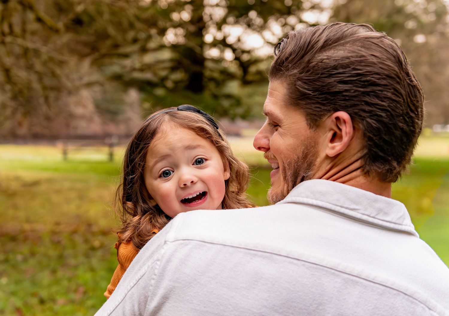 A joyful family moment captured outdoors in a park during a cool autumn day. Silverton, OR