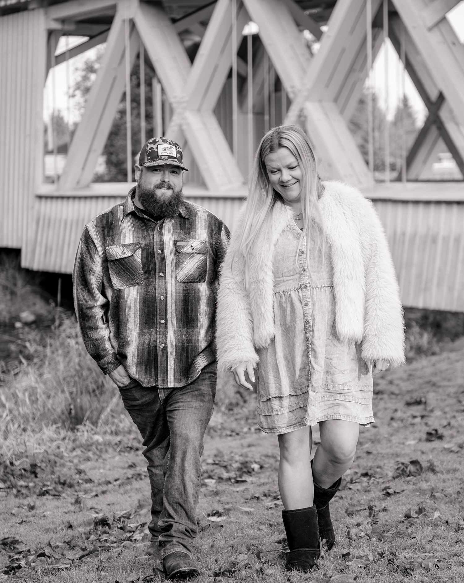 Detailed maternity image of mom and dad walking and conversating along a river in Stayton, OR