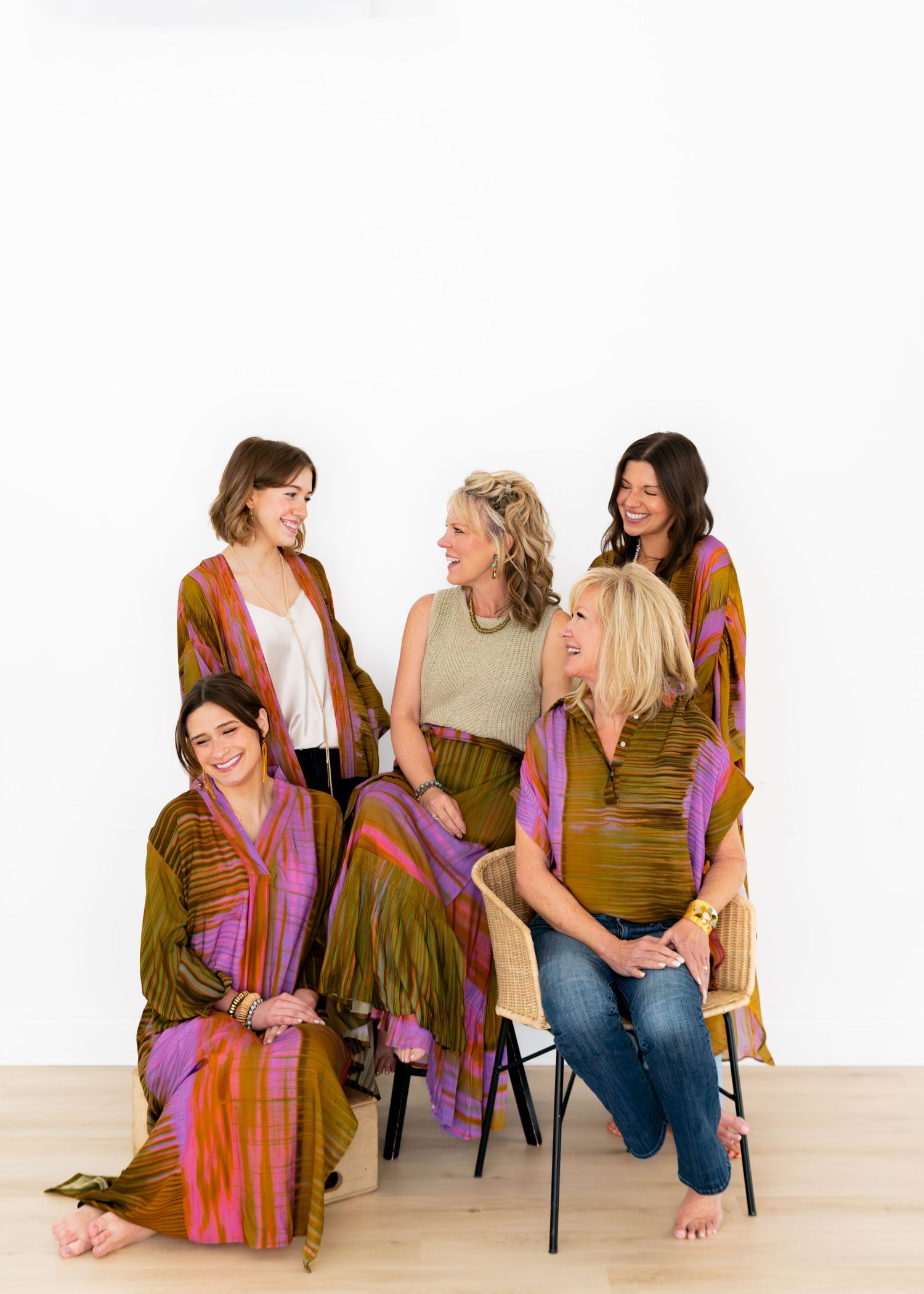 New clothing line photoshoot showcasing a group photo of women wearing different clothing items, displaying the same print in a studio.