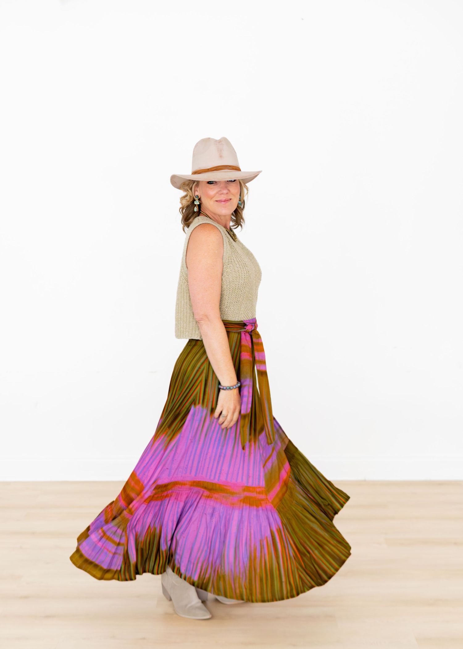 New clothing line photoshoot showcasing a woman wearing a skirt in a studio.