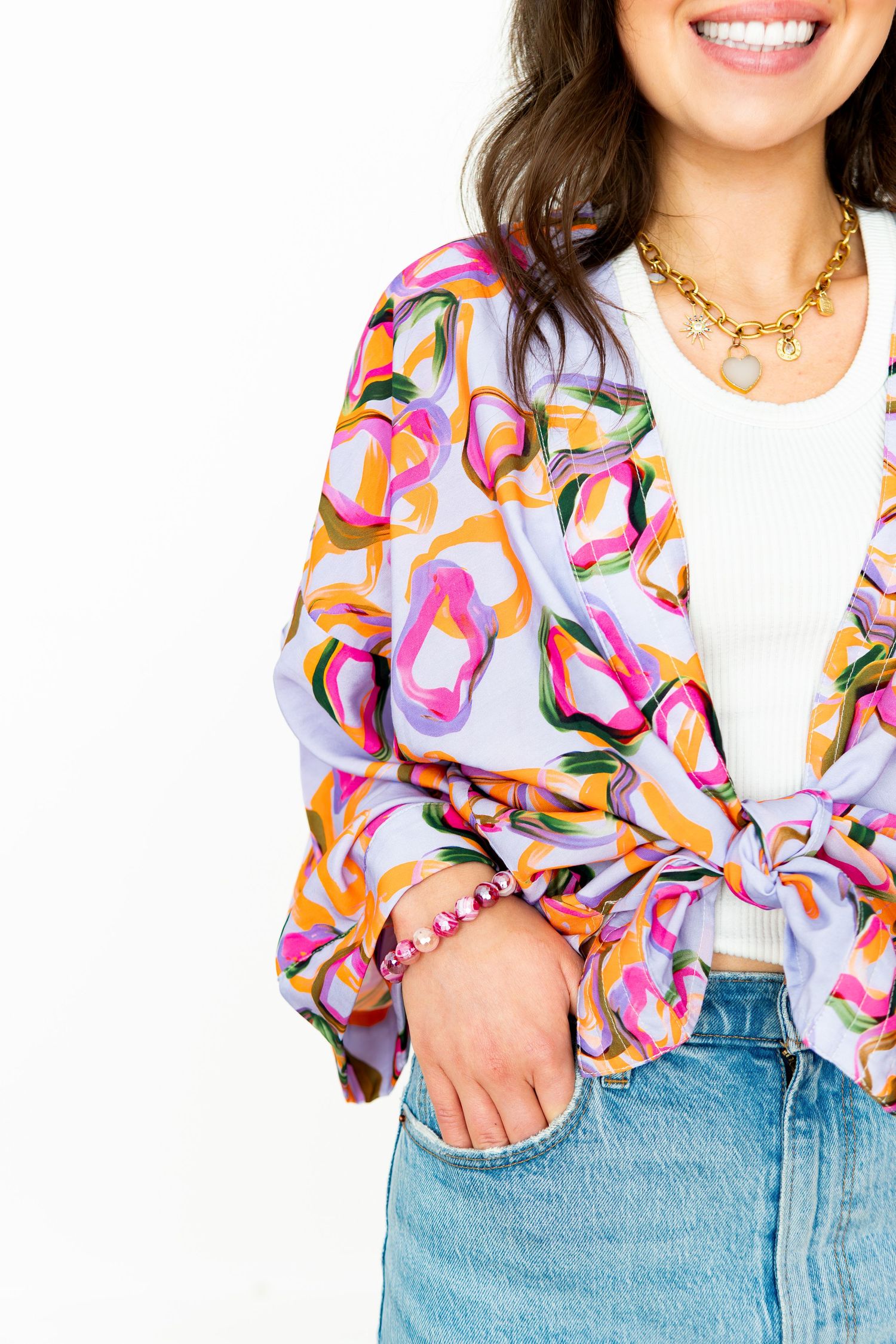 New clothing line photoshoot showcasing a close-up photo of a woman wearing a short kimono styled in a studio.