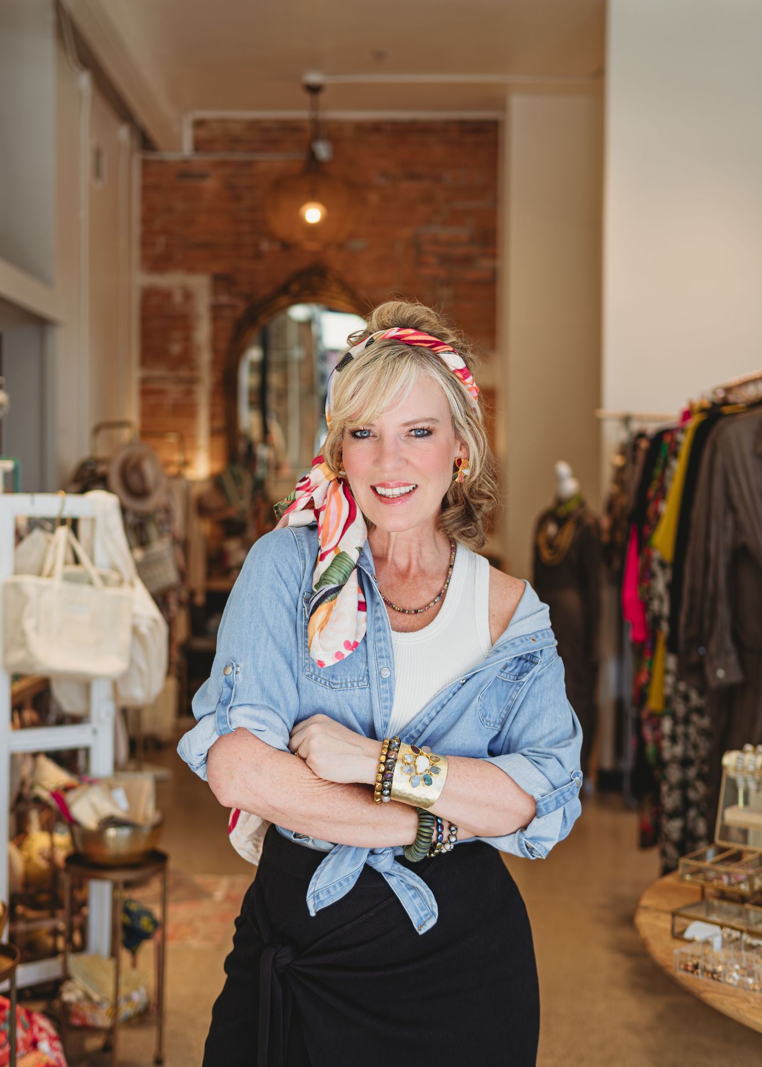Branding photoshoot inside a boutique showing a woman wearing a twilly accessory scarf on her head, displaying different ways for the brand.