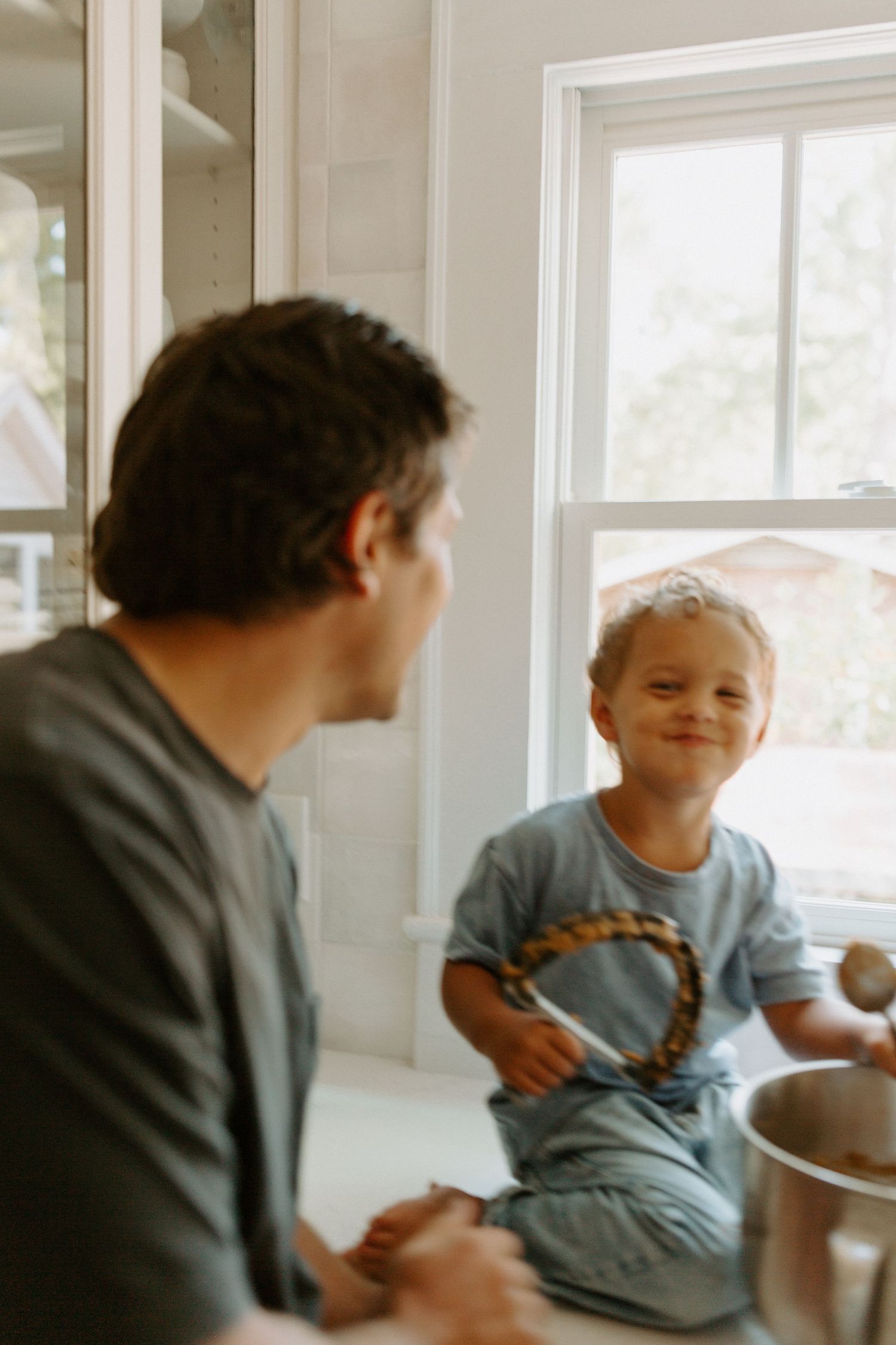 Candid moments of family baking together in bright kitchen.