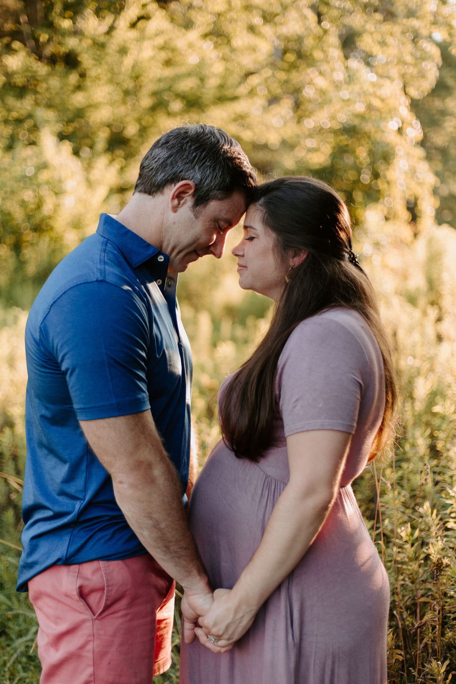 Intimate maternity photo series in a natural outdoor setting at golden hour.